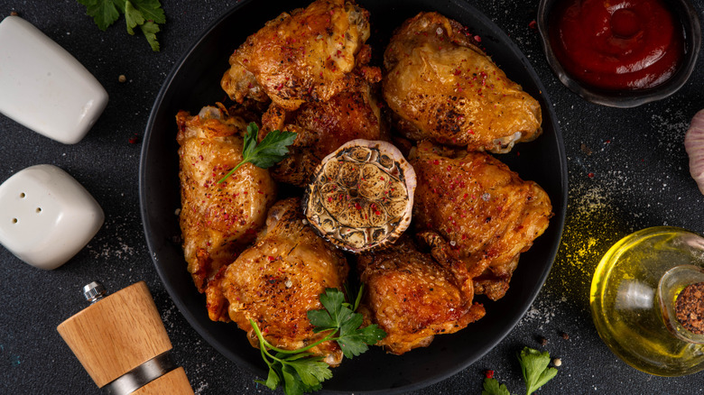 Seasoned baked chicken thighs with herbs and roasted garlic.
