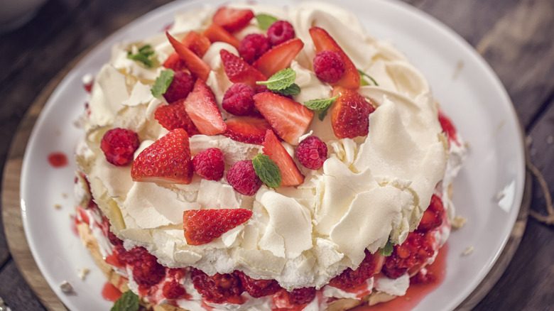 Berry pavlova made with meringue, mint, and berries