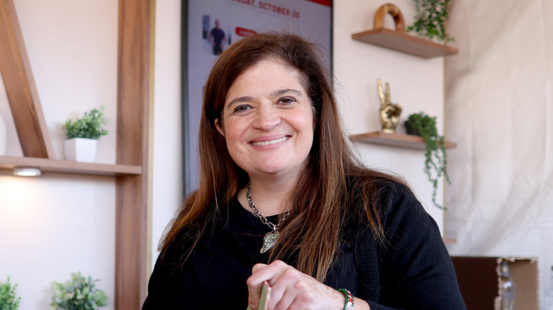 Alex Guarnaschelli smiling at a book signing