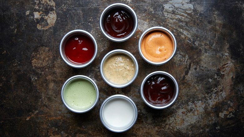 Bowls of barbecue sauces and condiments