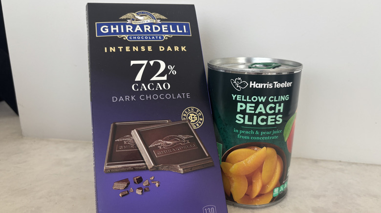 Chocolate bar and can of sliced peaches.