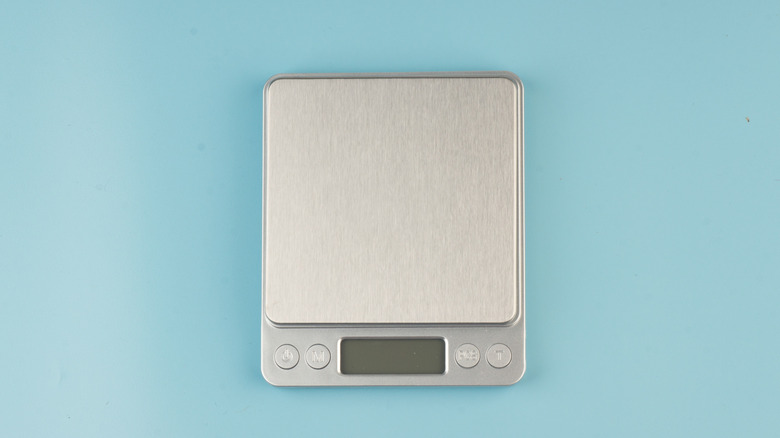 Digital kitchen scale on blue background