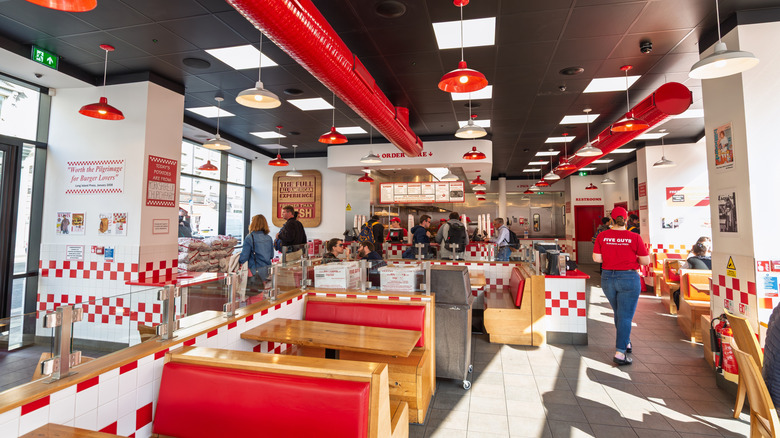 Customers order food inside a Five Guys restaurant