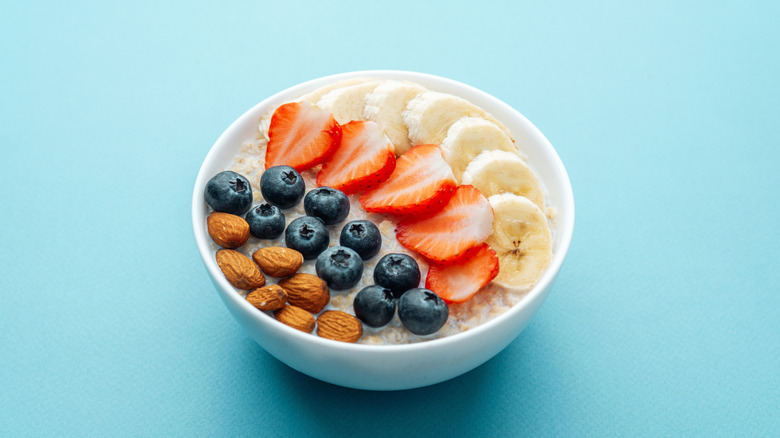 Almonds and fruit on a bowl of oatmeal