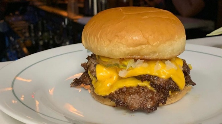 A double cheeseburger on a plate at Bar Arbolada in Oklahoma City