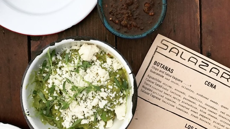 A bowl of guacamole and refried beans at Salazar in Los Angeles