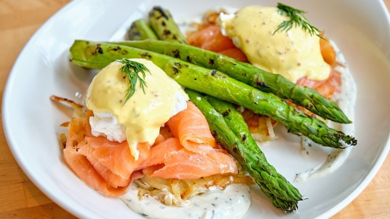 A plate of salmon eggs Benedict with asparagus from Seed Kitchen & Bar in Marietta, Georgia