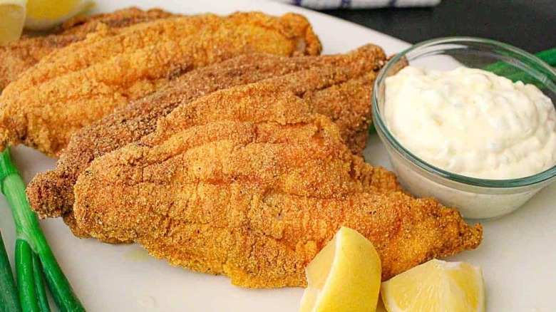 Pieces of fried catfish on a plate with tartar sauce at The Manna House