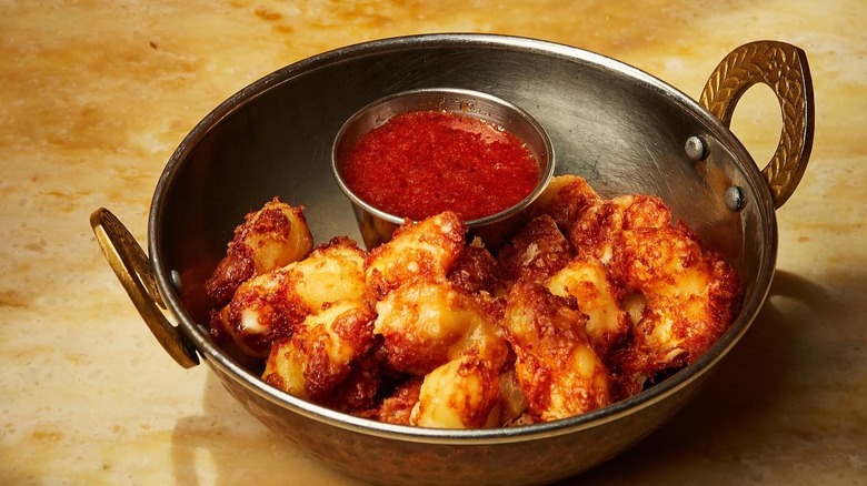 A bowl of cheese curds with hot honey at The Turk's Inn in Brooklyn, New York