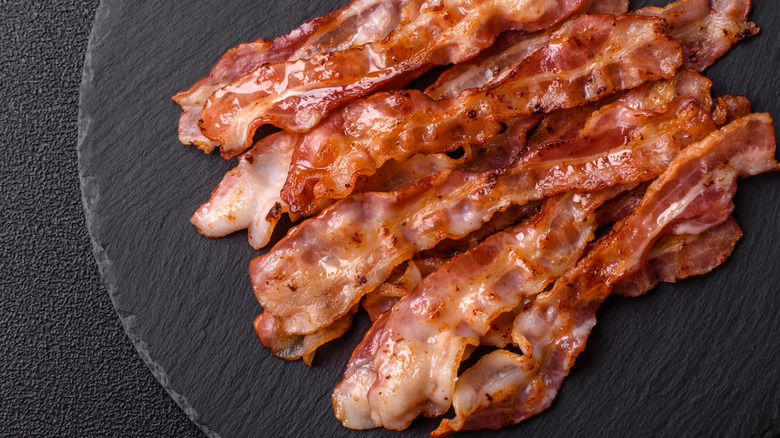 Greasy, freshly cooked bacon