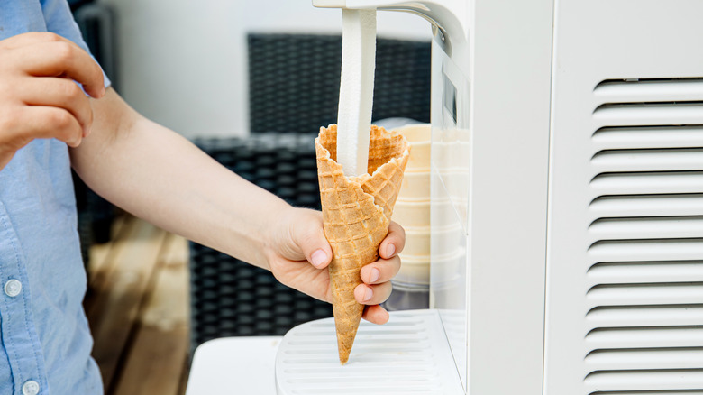 Person serving themselves soft serve ice cream