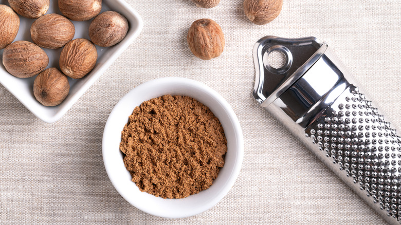 Whole nutmeg, ground nutmeg, and  a microplane