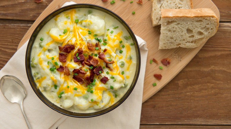 Cheesy potato soup garnished with bacon.
