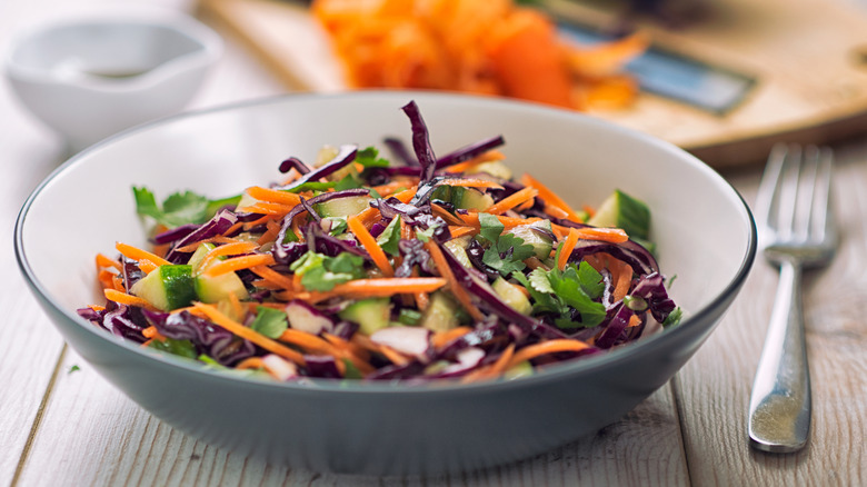 coleslaw components in a gray and white bowl