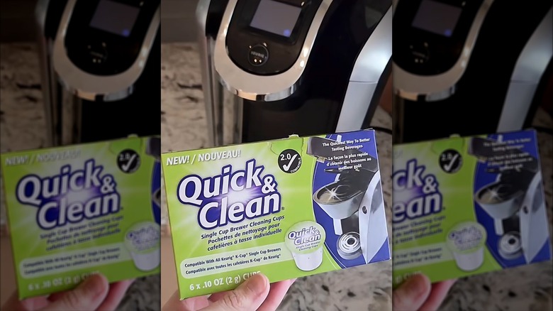 a hand holding a pack of Quick & Clean pods