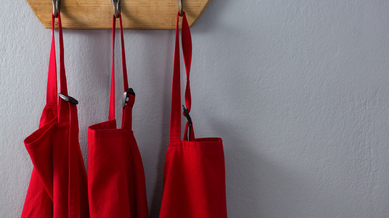 red aprons hanging
