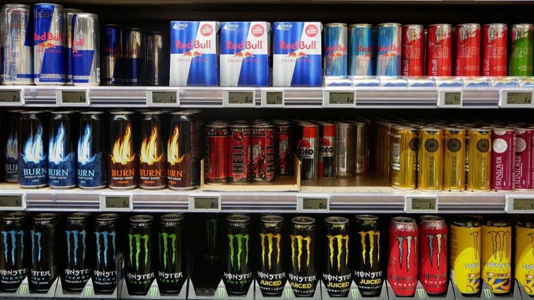 Energy drinks, including Red Bull, Burn, and Monster on a store shelf