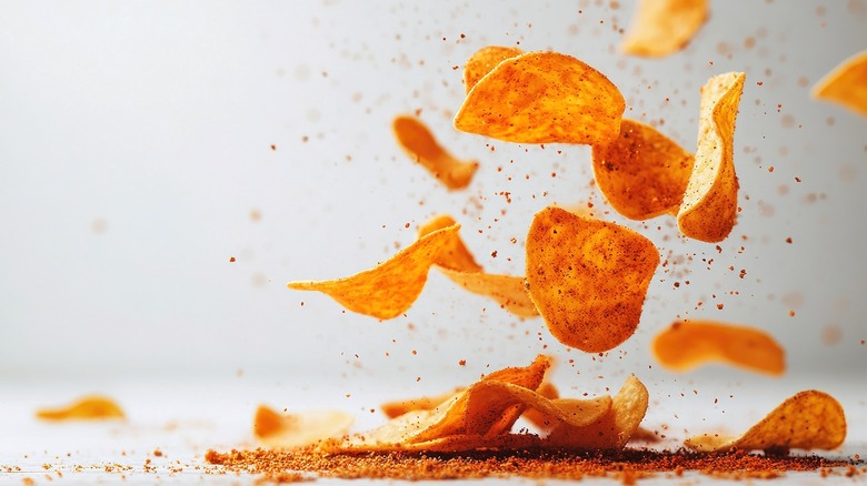 Seasoned chips and chip crumbs hovering in the air