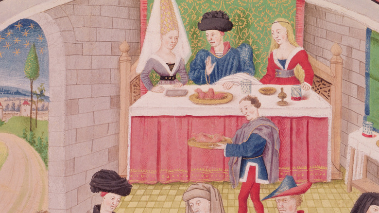 Illustration of royalty eating dinner from the Middle Ages.