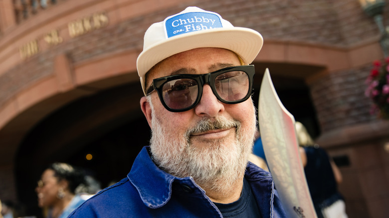 Andrew Zimmern wearing sunglasses and smiling