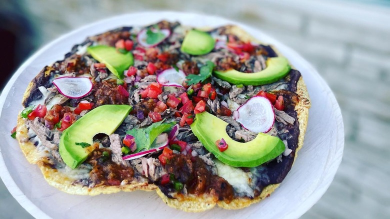 A tlayuda with meat and avocado at Oro by Nixta in Minneapolis