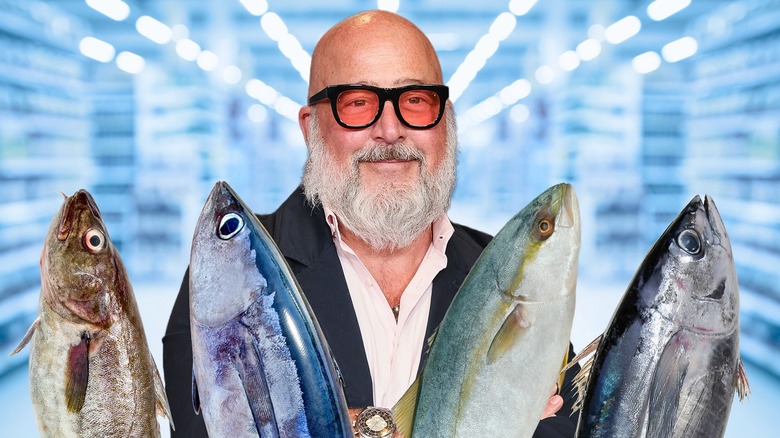 Andrew Zimmern with four types of fish