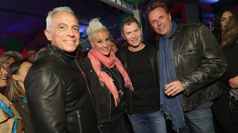 chef Anne Burrell standing with Bobby Flay and Geoffrey Zakarian