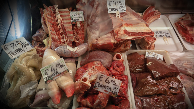 Various offal on display at a butcher shop