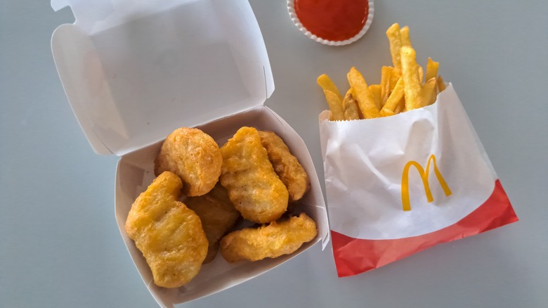 Box of McDonald's Chicken McNuggets with fries and ketchup