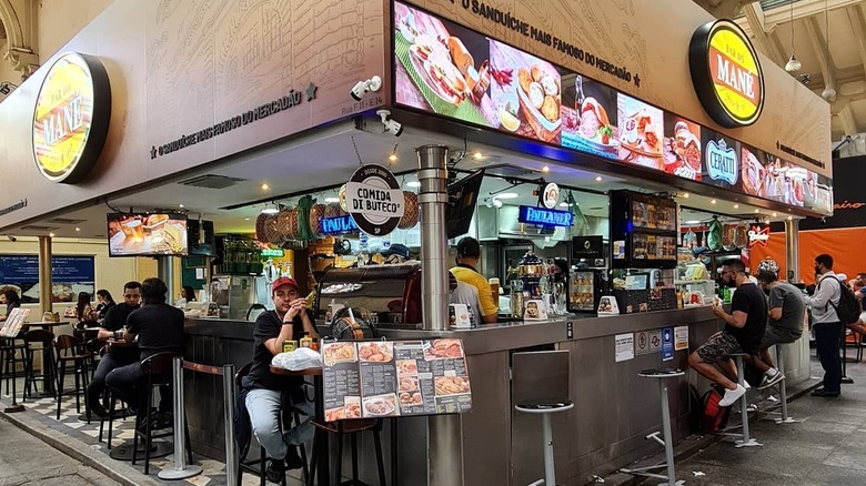 People sitting at the bar at Bar Do Mané in São Paulo