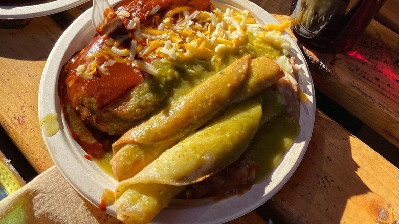A plate with beef taquitos with red and green sauces from Cielito Lindo in Los Angeles