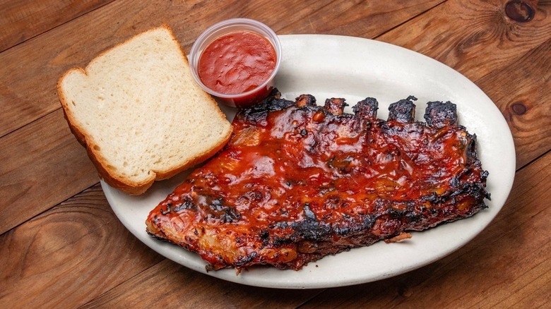 A rack of ribs with white bread and sauce from Fat Matt's Rib Shack in Atlanta