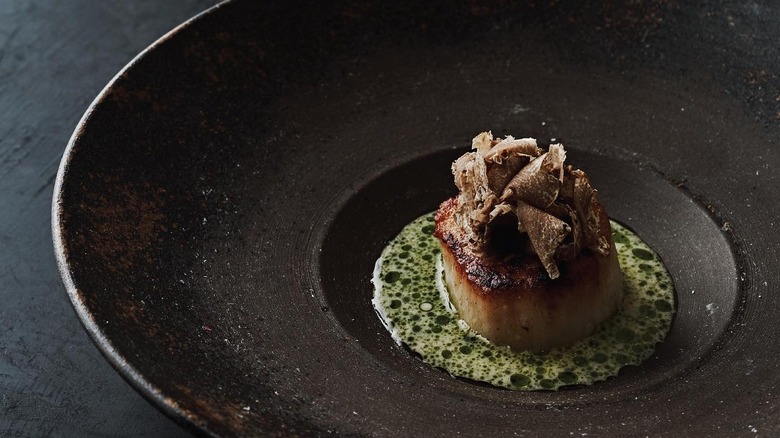 A scallop with truffles in a celery sauce from The Catbird Seat in Nashville