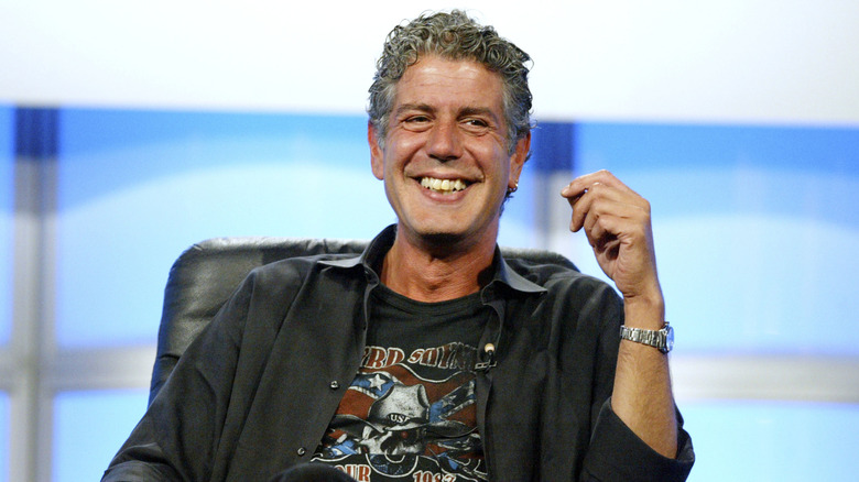 Anthony Bourdain smiles while on a panel