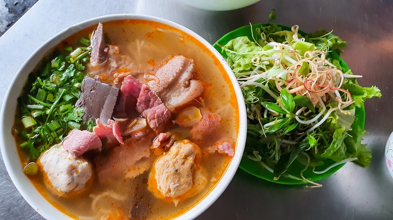 Bún bò Huế in bowl with salad