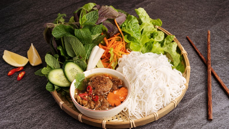 Bun cha with ingredients and wooden chopsticks