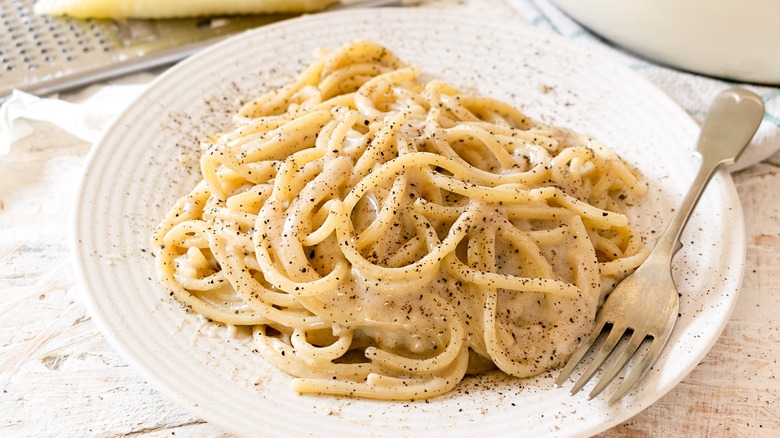 Cacio e pepe on white plate with fork