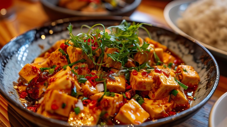 Mapo tofu on blue plate with greens