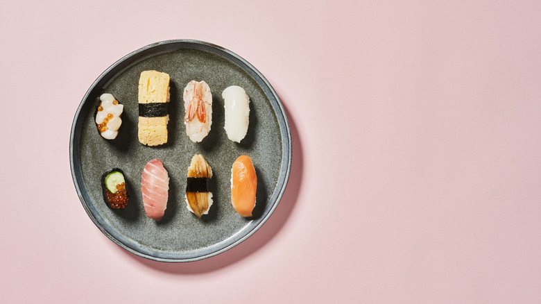 Sushi on grey plate and pink background