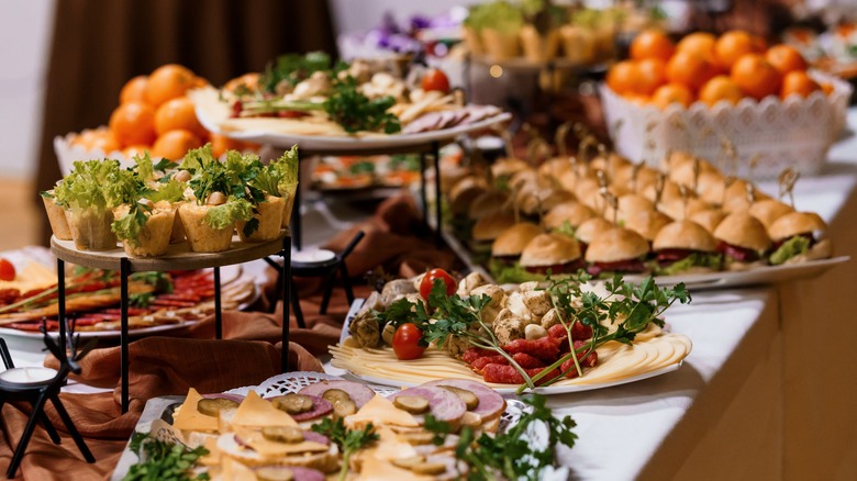 Table full of plates of various appetizers