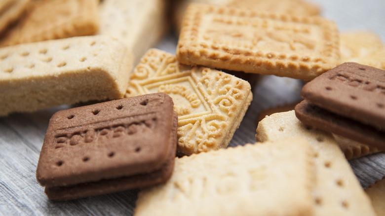 A selection of British style biscuits on a wooden surface.
