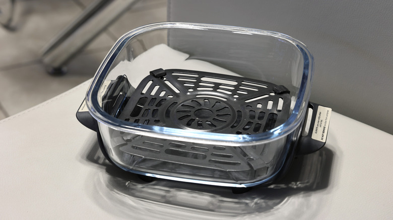emty glass air fryer insert on white table