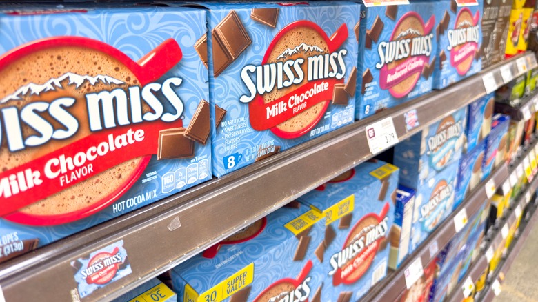 Several boxes of hot chocolate on a grocery store shelf