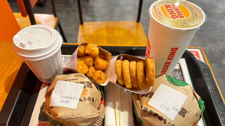 Burger King Meal with two sandwiches, two drinks, and onion rings