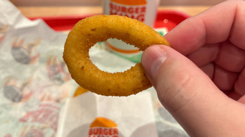 Hand holding a Burger King Onion Ring