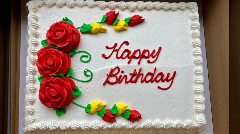 A white Birthday sheet cake with flowers