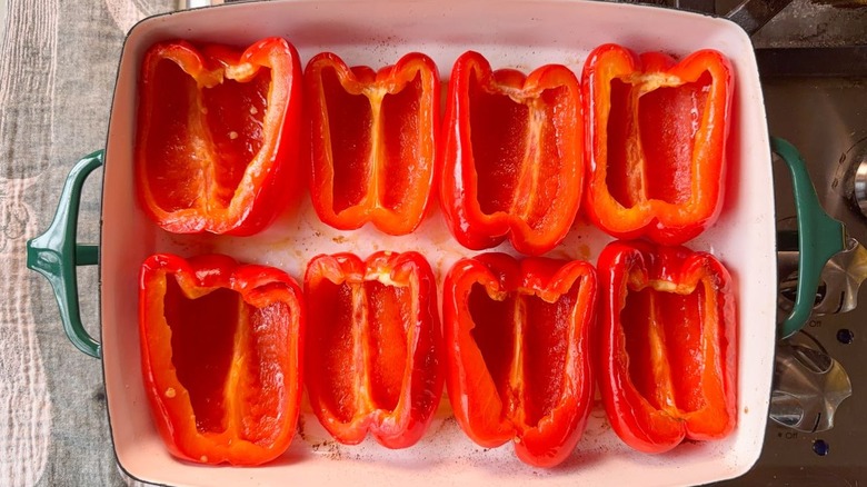 Roasted red bell pepper halves cut-side-up in baking dish