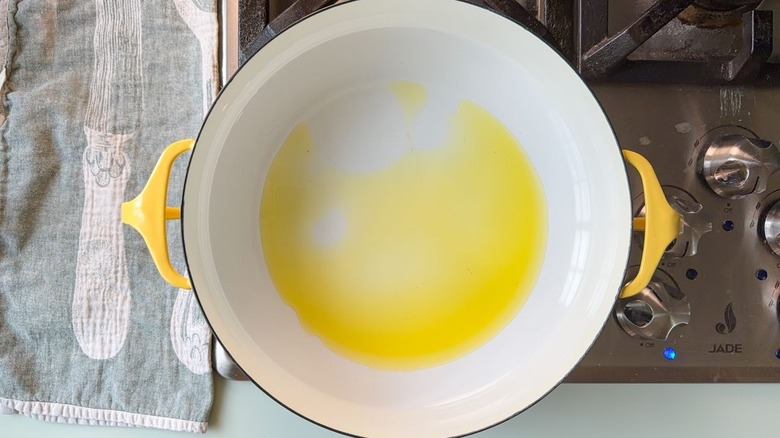 Yellow pot with olive oil on stovetop