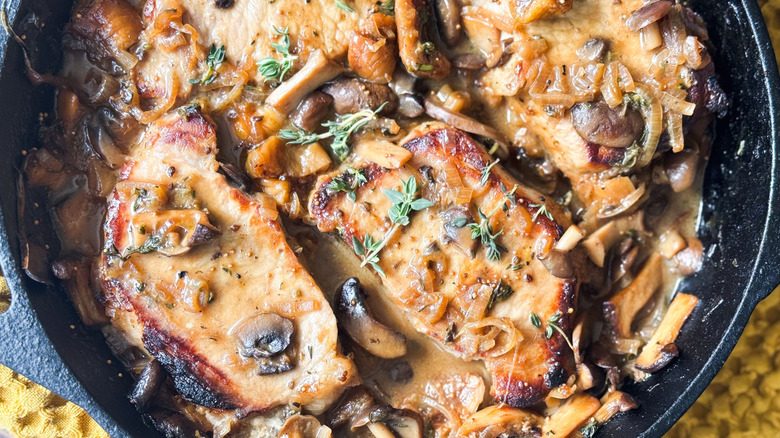 Aromatic smothered pork chops close up