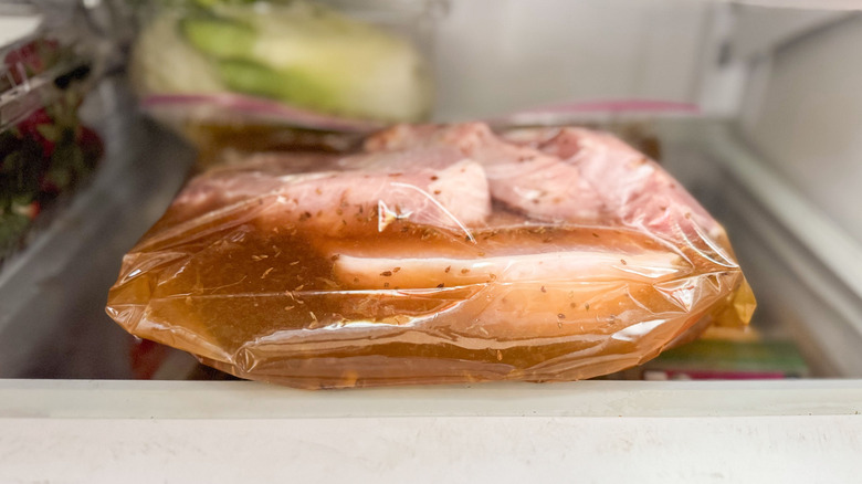 Pork chops and brine in ziplock bag in refrigerator